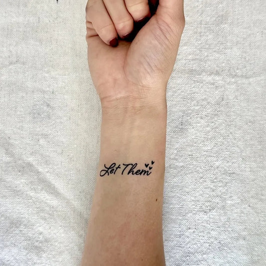 Small Script Let Them Script with Stars on Women Wrist Tattoo by @consciousink