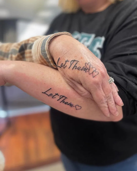 Small Script Let Them Text and Heart on Women Forearm Tattoo by @jabbedbygab