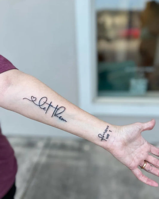 Small Script Let Them and Heart on Women Arm Tattoo by @diamondgtattoo
