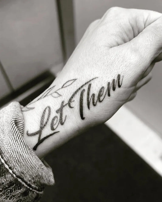 Small Script Let Them and Leaves on Women Wrist Tattoo by @brittanycarp_