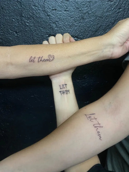 Small Script Let Them on Women Arms Tattoo by @untamed_tattoo_studio