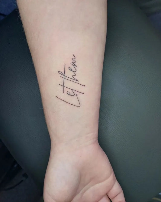 Small Script Let Them on Women Forearm Tattoo by @ink.toxicated