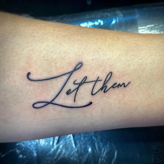 Small Script Let Them on Women Forearm Tattoo by @raynestormxtattoos