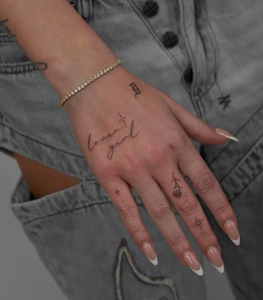 Small Script Lovegirl Rose Star on Women Hand Tattoo by @ayasha.luna