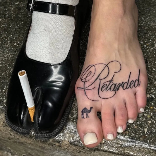Small Script Word and Camel Tattoo on Women Foot by @ignorantstyletattoo