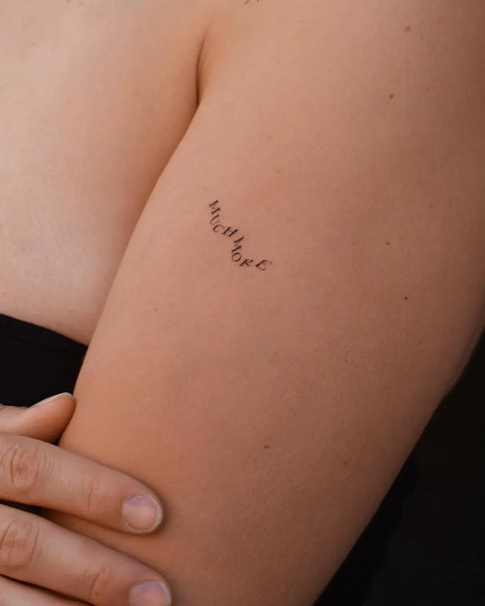 Small Script Word on Women Arm Tattoo by @gwen.tattooing