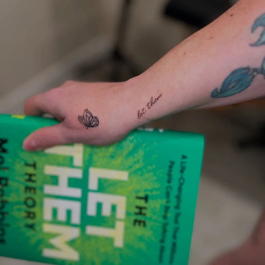 Small Script and Illustrative Butterfly and Let Them on Women Forearm Tattoo by @inkedbyjaimie