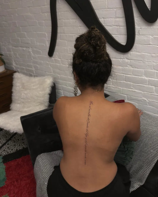 Small Script on Women Spine Tattoo by @yourcrush.tattoos