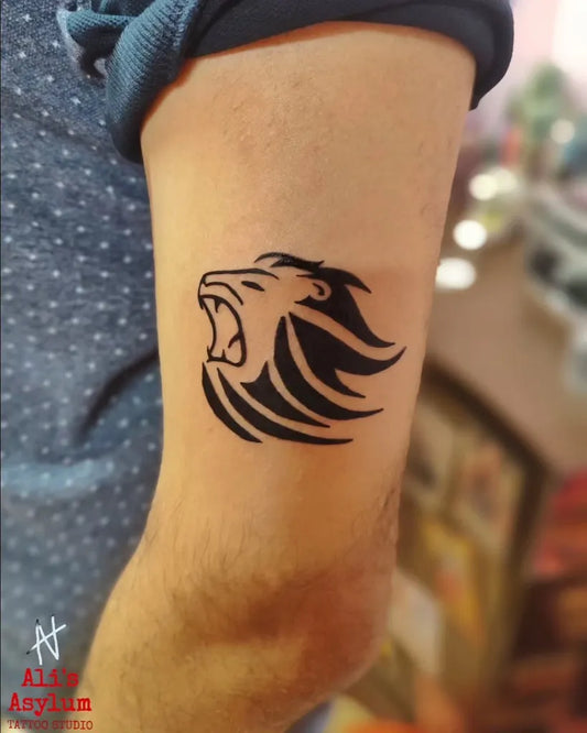 Small Simple Blackwork Lion Men Arm Tattoo by @alis.asylum.tattoo