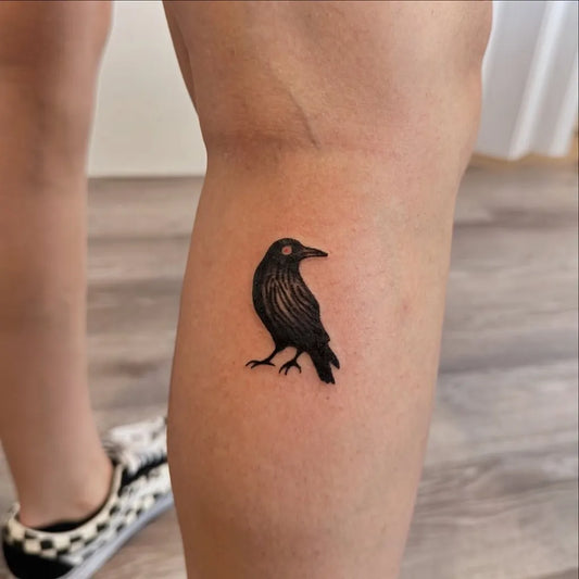 Small Simple Blackwork Raven on Women Leg Tattoo by @annie_tattoos