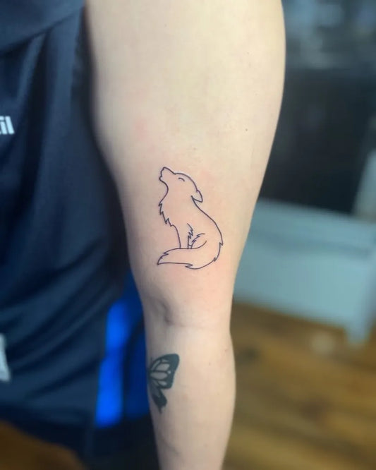 Small Simple Wolf Outline on Men Arm Tattoo by @daniel_rickard_tattoos