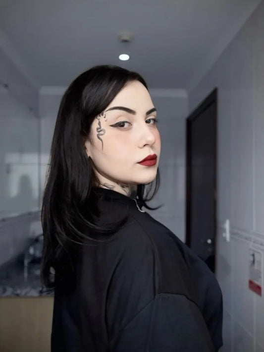 Small Snake Skull on Women Face Tattoo by @lior.giu