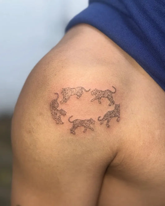Small Stick and Poke Circle of Tigers Tattoo on Men Shoulder by @eah.poke