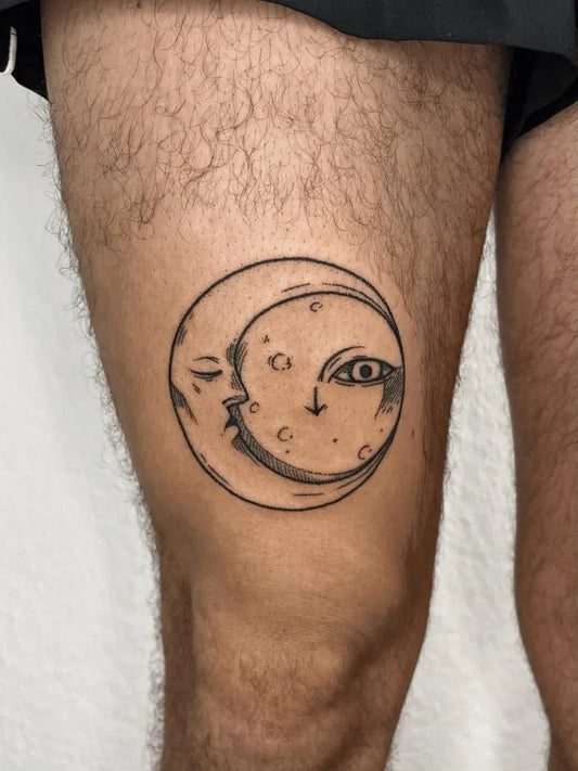 Small Stick and Poke Crescent Moon Face Tattoo on Men Thigh by @jhg.tattoo