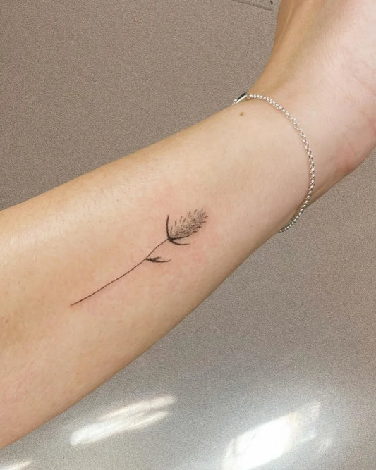 Small Stick and Poke Grass Stem Tattoo on Women Wrist by @puddingclubpokes