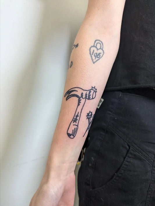Small Stick and Poke Hammer Lock Heart Tattoo on Women Arm by @starttodaytattoo