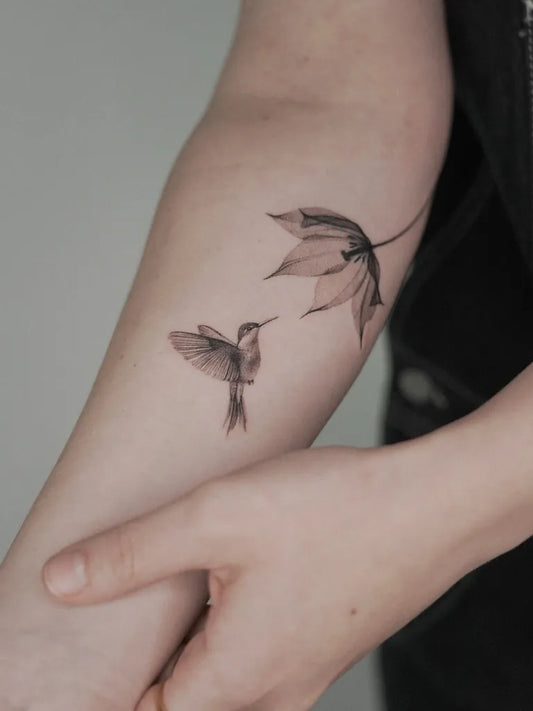 Small Stick and Poke Hummingbird and Leaf Tattoo on Women Arm by @maria_pokes