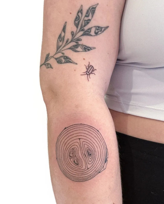 Small Stick and Poke Leaf Branch Beetle and Spiral Circle Tattoo on Women Arm by @pineneedle.p