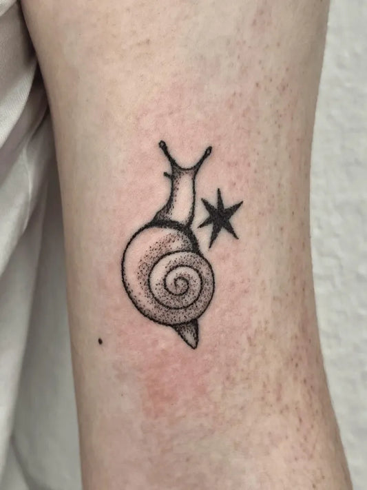 Small Stick and Poke Snail and Star Tattoo on Women Arm by @jhg.tattoo