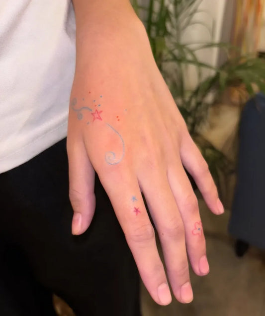 Small Stick and Poke Spiral Stars Tattoo on Women Hand by @mardi.poke