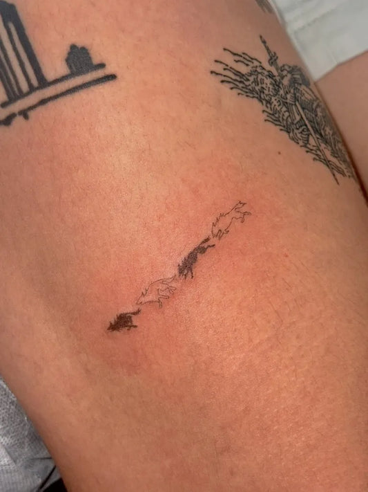 Small Stick and Poke Wolf Silhouette Tattoo on Women Thigh by @eah.poke