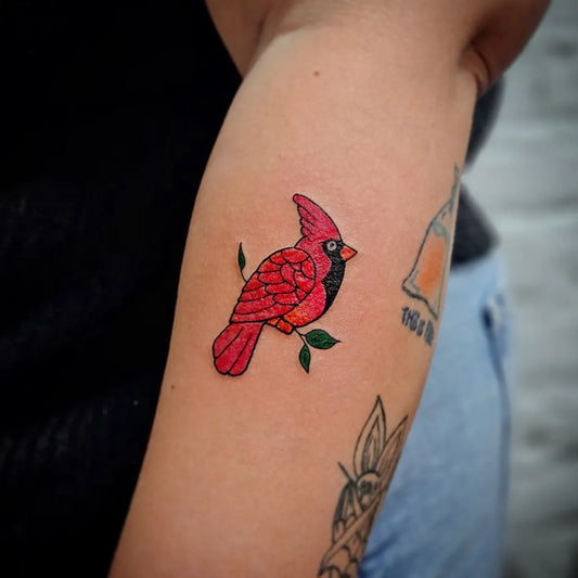 Small Traditional Cardinal Bird Tattoo on Women Arm by @libertycentertattooshop