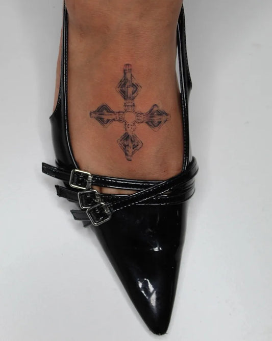Small Traditional Cross on Women Foot Tattoo by @skn.tattooco