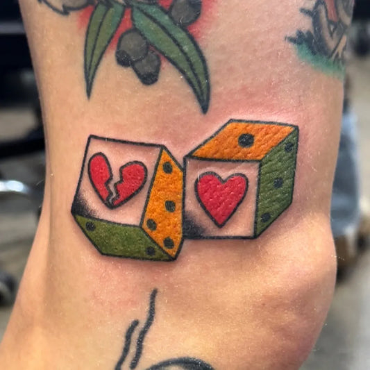 Small Traditional Dice Hearts Tattoo on Women Arm by @joelfrenchtattoos