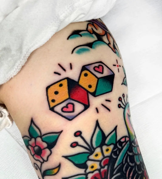 Small Traditional Dice Hearts Tattoo on Women Arm by @theneedlestattoo