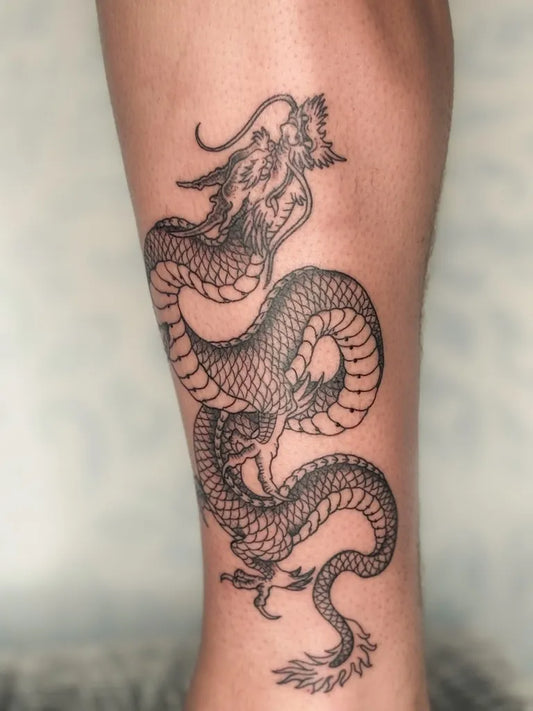Small Traditional Dragon on Men Leg Tattoo by @consciousartstattoos