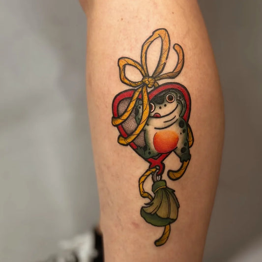 Small Traditional Frog Heart Tattoo on Women Leg by @joanarasteiro.pt