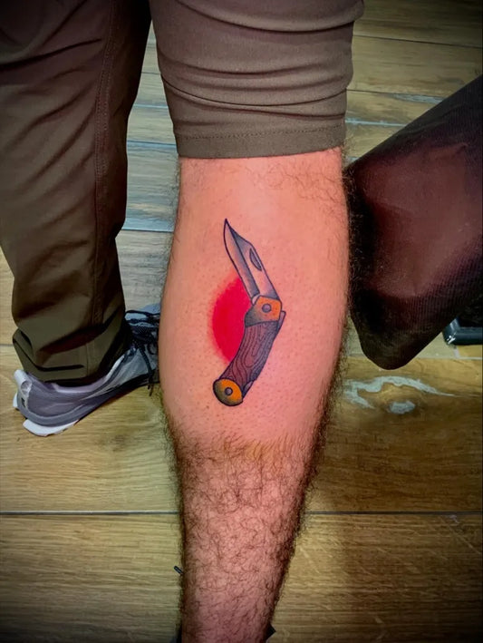 Small Traditional Knife Tattoo on Men Leg by @art__by__zaya