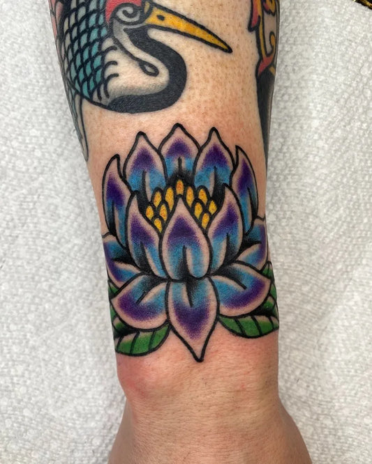 Small Traditional Lotus Flower on Women Wrist Tattoo by @oc_tattoos_
