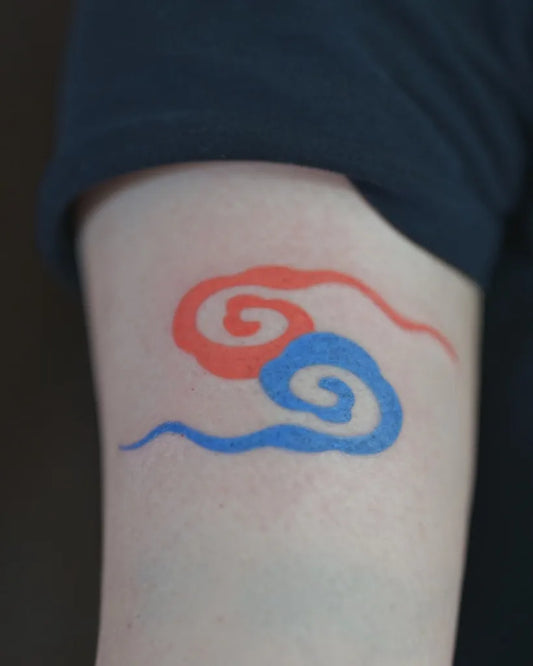 Small Traditional Red and Blue Cloud Tattoo on Men Arm by @hansiitattoo
