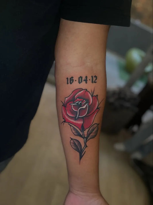 Small Traditional Rose Date on Women Arm Tattoo by @vinl55_does_tattoos