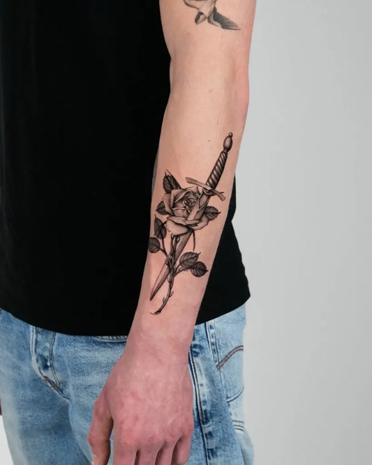 Small Traditional Rose and Dagger on Men Arm Tattoo by @matt_hewittt