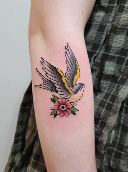 Small Traditional Sparrow and Flower Tattoo on Women Arm by @little.mustard.ink