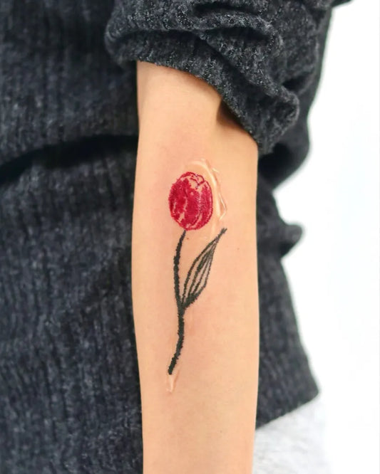 Small Traditional Tulip Tattoo on Women Arm by @tina_colortattooist