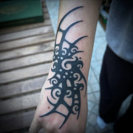 Small Tribal Abstract Spikes and Spirals on Men Wrist Tattoo by @taul.ttt