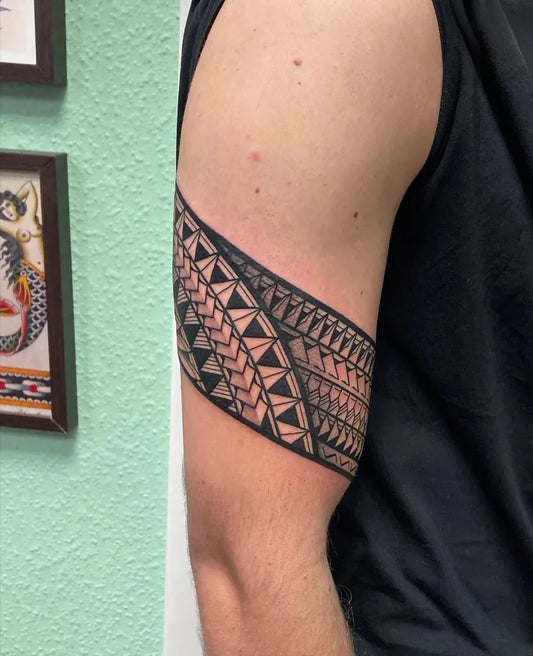 Small Tribal Band on Men Arm Tattoo by @bladeandshade