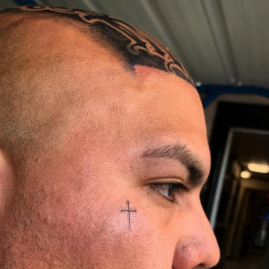 Small Tribal Cross on Men Face Tattoo by @studio1990