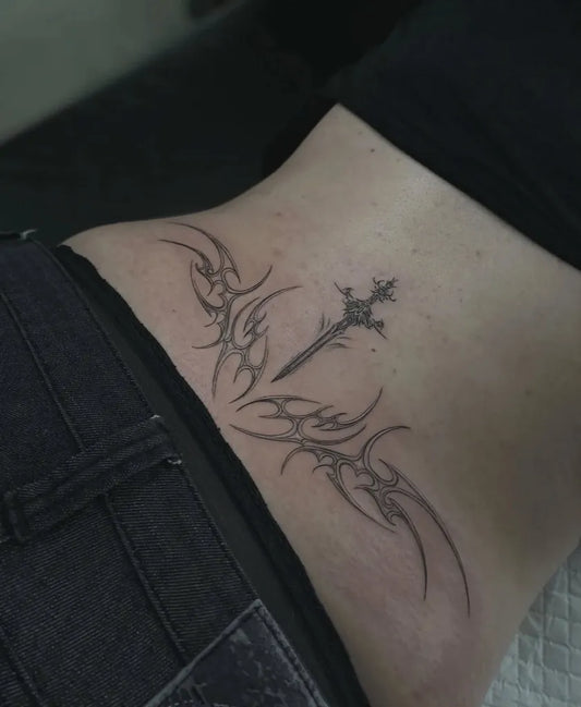 Small Tribal Cross on Women Back Tattoo by @basilmccabetattoos