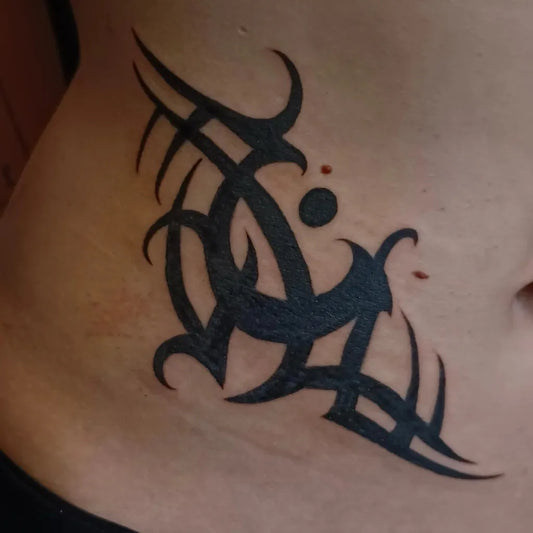 Small Tribal Wings and Dots on Women Abdomen Tattoo by @rockinrobertart