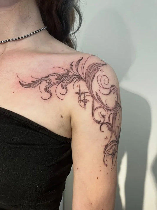 Small Tribal floral swirls with cross on Women shoulder Tattoo by @miyagi_ink