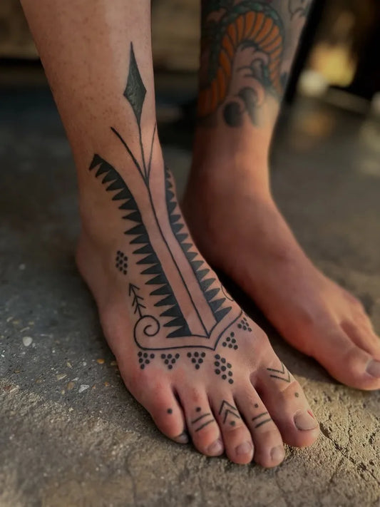 Small Tribal geometric patterns arrowhead zigzag lines on Women Feet Tattoo by @daphne.tattoo