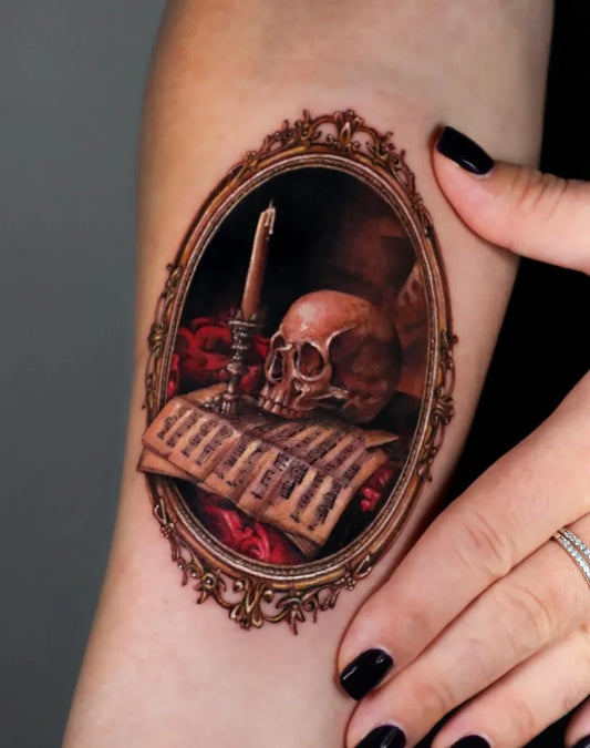 Small Victorian Skull Sheet Music Candle on Women Arm Tattoo by @marily_tattoo