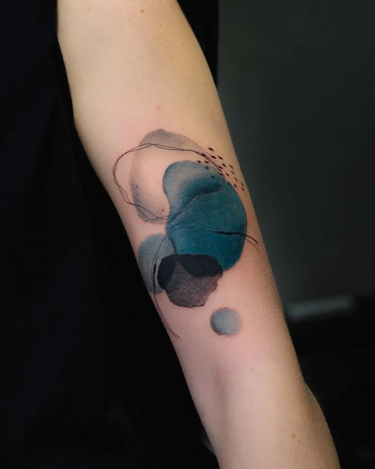 Small Watercolor Abstract Blue Shapes on Women Arm Tattoo by @dantepaolucci
