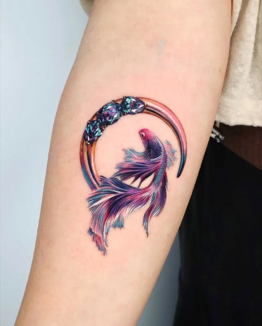 Small Watercolor Betafish and Hoop Tattoo on Women Arm by @non_lee_ink