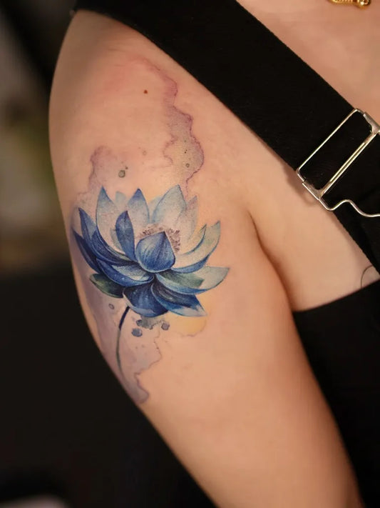Small Watercolor Blue Lotus Flower on Women Arm Tattoo by @dinhkhang.wrk