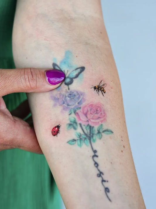 Small Watercolor Butterfly Bee Roses on Women Arm Tattoo by @tattoo.by_jinnie